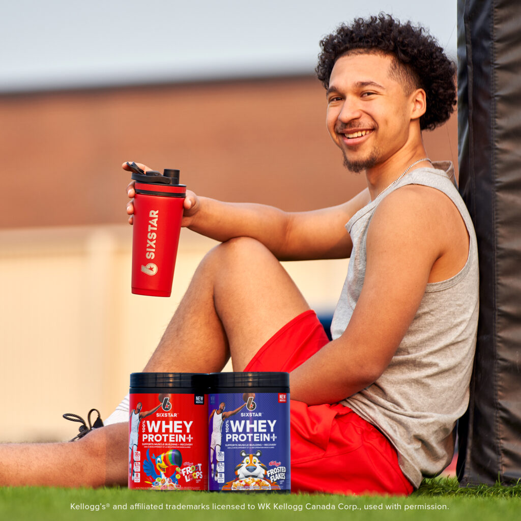 Athlete sitting with SIXSTAR 100% Whey Protein Plus Kellogg's Froot Loops® and 100% Whey Protein Plus Kellogg's Frosted Flakes®