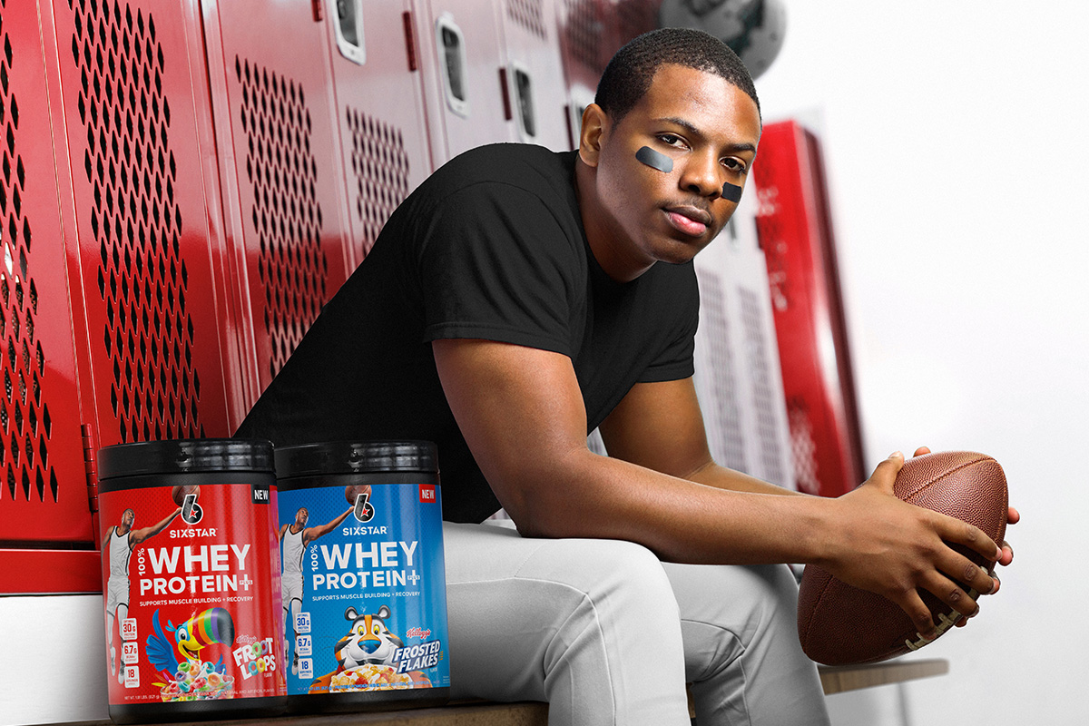 Football player in lockeroom with SIXSTAR 100% Whey Protein Plus Frosted Flakes and 100% Whey Protein Plus Fruit Loops